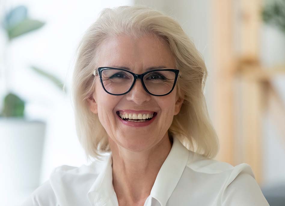 older woman smiling with dental imlpants